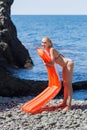 Slim young woman resting on wild shingle beach Royalty Free Stock Photo