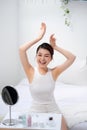 Slim young woman shows tender smooth armpit skin in bedroom Royalty Free Stock Photo