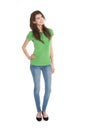 Slim young woman wearing green shirt and blue jeans in full body