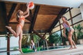 Slim young women playing with a beach ball at indoor swimming pool Royalty Free Stock Photo