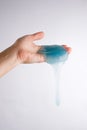 Slime glue a toy for children mucus and liquid flowing on hand.