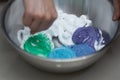 Slime ingredients in mixing container with blur hand working on