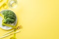 Slimming concept. Top view photo of plate with cauliflower glass of water measuring tape knife and fork on isolated pastel yellow Royalty Free Stock Photo