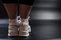 Slimming exercises. Yoga for everyone. Women`s legs in sneakers. A plump girl in sneakers Royalty Free Stock Photo