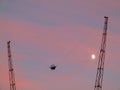 Slingshot extreme ride into purplish sky at dusk by moon shine