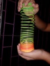 Slinky spring toy spread hold by a child