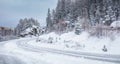 Slipery country road in snowy forest in winter. No cars.