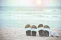 Slippers of the family on the beach and the sea as the background blurred. Royalty Free Stock Photo