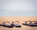 Slippers on the Sandy Beach Vacation Time Royalty Free Stock Photo