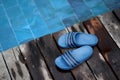 Slippers or shoes on wooden poolside for beach summer swimming pool vacation holiday concept Royalty Free Stock Photo