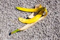 Slippery banana peel laying on ground ready to make someone slip and fall