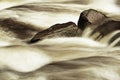 Slippery boulders in mountain stream. Clear water blurred by long exposure, low water level. Royalty Free Stock Photo