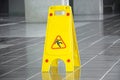 Slippery floor surface warning sign and symbol in building, hall