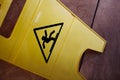 Slippery floor yellow caution sign on tiled floor top down view Royalty Free Stock Photo