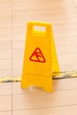 Slippery icon on yellow plastic warning sign alerts for hazard o Royalty Free Stock Photo