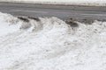 Slippery slushy snow with tire marks and ruts at road entrance to highway Royalty Free Stock Photo