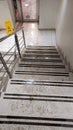 Slippery stairs in the mud in an office building, snow melted on the stairs