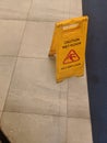 Slippery warning board sign on the top of the floor that have been mopped Royalty Free Stock Photo