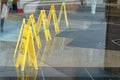 Slippery when wet yellow foldable sign to show dangerous area with puddle in restaurant or business for saftey Royalty Free Stock Photo