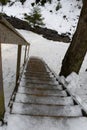 Slippery wooden stairs covered with ice in winter