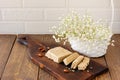 Slised sunfower halva dessert on a serving wooden board on a table. Sweet oriental dessert from nuts and seeds