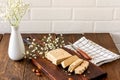 Slised sunfower halva dessert on a serving wooden board on a table. Sweet oriental dessert from nuts and seeds