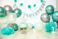 sliver, blue and white decoration for a 1st birthday cake smash studio photo shoot with balloons, paper decor, cake and Royalty Free Stock Photo
