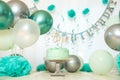 sliver, blue and white decoration for a 1st birthday cake smash studio photo shoot with balloons, paper decor, cake and Royalty Free Stock Photo