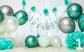 sliver, blue and white decoration for a 1st birthday cake smash studio photo shoot with balloons, paper decor, cake and Royalty Free Stock Photo