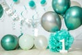 sliver, blue and white decoration for a 1st birthday cake smash studio photo shoot with balloons, paper decor, cake and Royalty Free Stock Photo