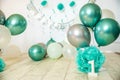 sliver, blue and white decoration for a 1st birthday cake smash studio photo shoot with balloons, paper decor, cake and Royalty Free Stock Photo