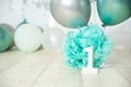 sliver, blue and white decoration for a 1st birthday cake smash studio photo shoot with balloons, paper decor, cake and Royalty Free Stock Photo