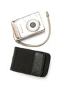 A sliver metallic digital compact point-and-shoot camera with matching black case white backdrop Royalty Free Stock Photo