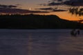 Sliver moon over a lake