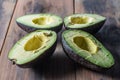 Slives of ripe avocado on rustic surface Royalty Free Stock Photo
