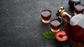 Slivovica - plum vodka, plum brandy in a bottle on a black stone table. Glasses with alcoholic beverage. Royalty Free Stock Photo