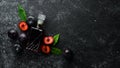 Slivovica - plum vodka, plum brandy in a bottle on a black stone table. Glasses with alcoholic beverage. Royalty Free Stock Photo