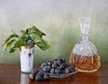 Slivovitz crystal bottle and plums Royalty Free Stock Photo