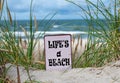 The slogan \'life\'s a beach\' in the sand dunes at the beach. Royalty Free Stock Photo