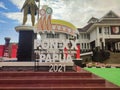 the slogan and logo of the XX Papua PON 2021 installed against the background of the ANIM-HA statue