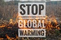 The slogan of stop global warming and stop burning on the background of fire Royalty Free Stock Photo