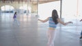 Slomo shot of girls spinning on roller skates under roof outdoors