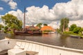 Sloop in front of an old sailing boat in a canal in the Dutch village of Heeg, Friesland, The Netherlands Royalty Free Stock Photo