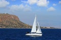 Sloop sailboat on a quiet sea in open waters.