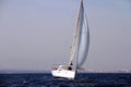 Sloop sailboat on a quiet sea in open waters. Royalty Free Stock Photo