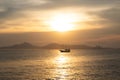 A sloop sailing with tourists in the bay of Santos, Brazil, during a sunset Royalty Free Stock Photo