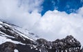 Slope of Mount Etna crater, Sicily island in Italy. Close view of volcanic lava rocks and stones covered with snow in Royalty Free Stock Photo