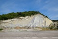 slope of the mountain with layers of sedimentary rocks. Vertically located sedimentary rocks on collapsing hillside Royalty Free Stock Photo