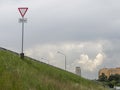 The slope of the road. Give way yield road traffic sign