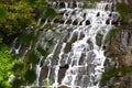 On the slope of the stones flows water in the park. Royalty Free Stock Photo